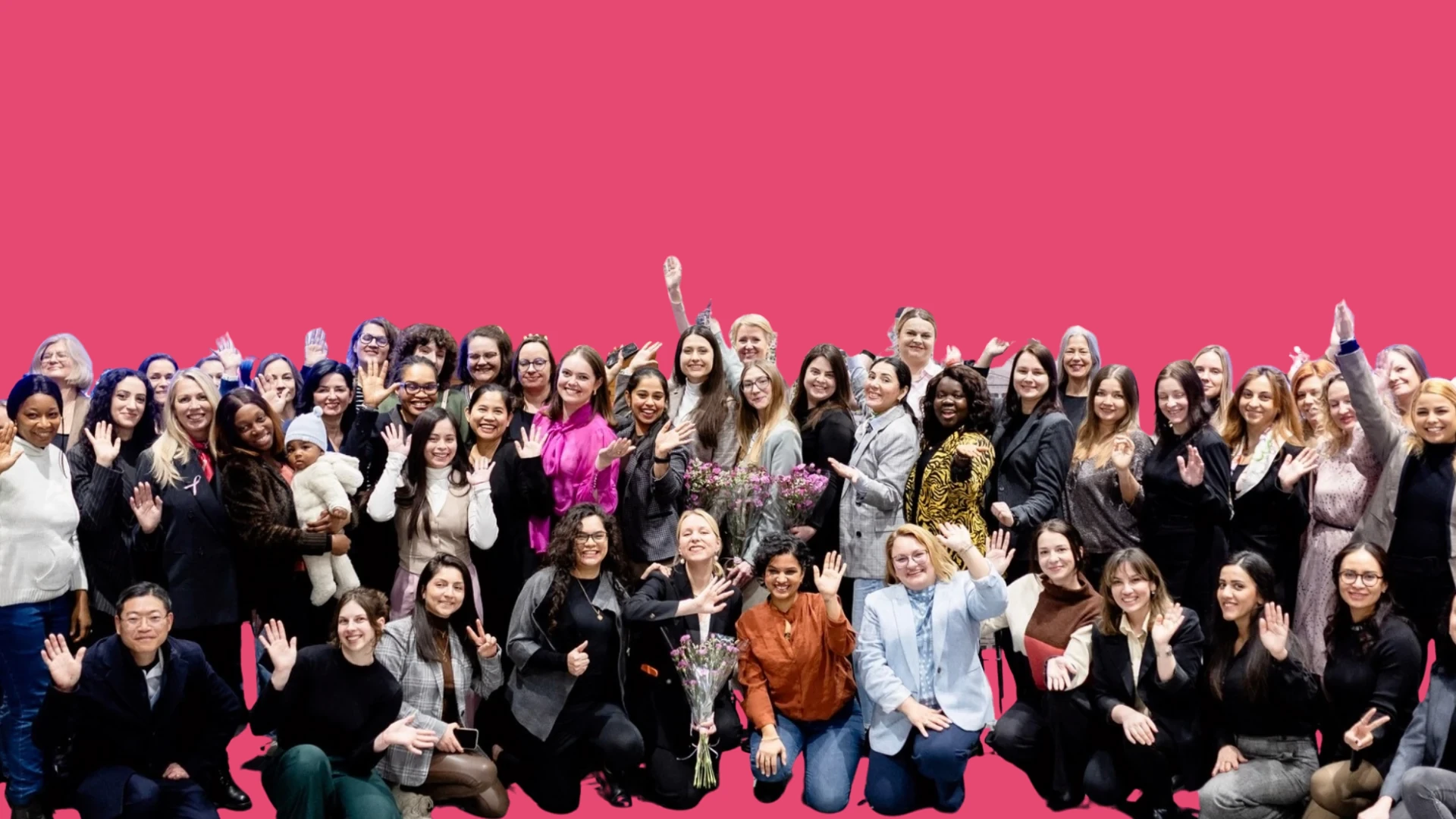 Opening night group portrait of the 1000 Women Project with a stylized pink background
